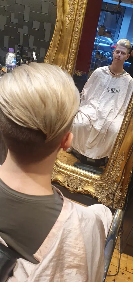 Hair colour, after: blonde from behind, reflected in a gilded mirror