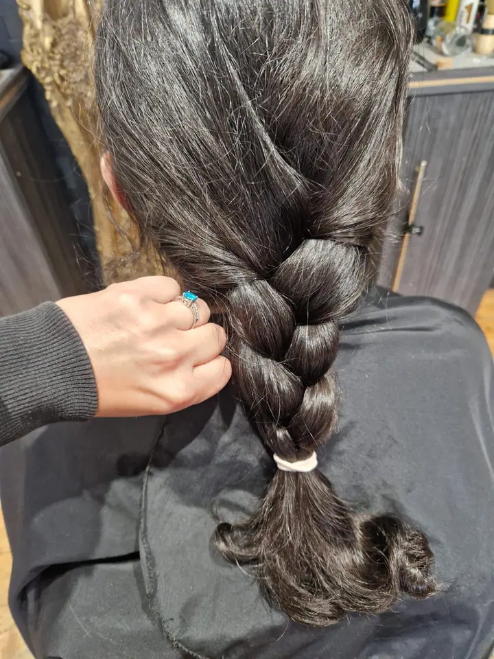 Long dark hair in a single plait