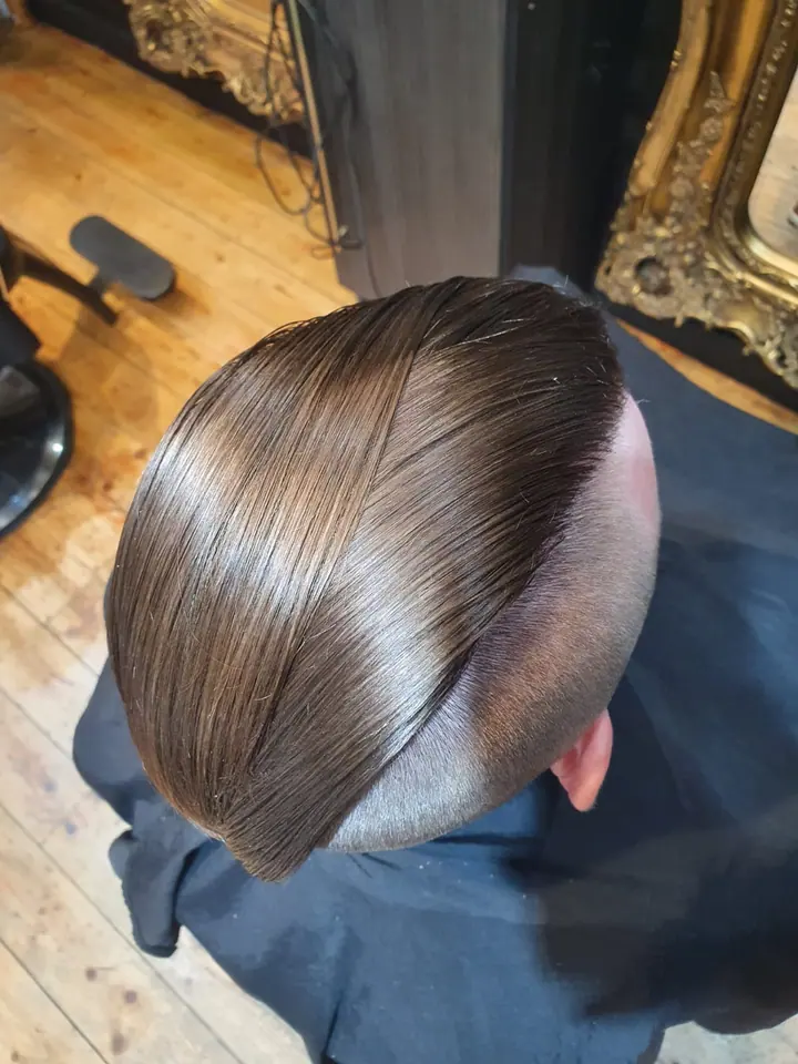Slicked side part with a skin fade, from above